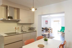 a kitchen and living room with a table and chairs at Duplex con vistas en el centro de Aracena in Aracena +23 photos