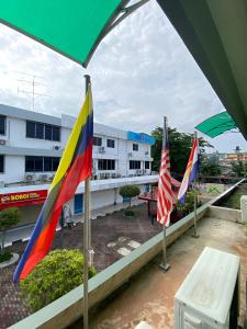 a view from the balcony of a building with flags at Perdana Hotel Labuan in Labuan