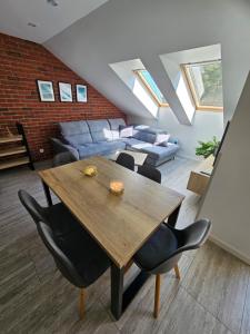 a living room with a wooden table and chairs at Apartamenty Platinum 2 in Łukęcin