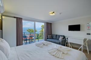 a hotel room with a bed and a balcony at Miralya Rooms in Fethiye