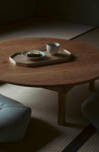 a coffee table with a plate and a cup on it at 宿屋 余白丨yadoya yohaku in Wakayama
