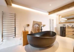 a large black bath tub in a room at The Angel at Hetton in Hetton +50 photos