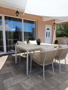 a white table and chairs on a patio at Apartment Andrija in Šibenik