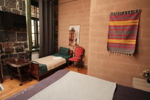 a room with two beds and two chairs at Onoyi Tun Guest House in Gyumri