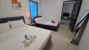 a hotel room with a bed and a couch at Plumera Mactan Condo unit in Bankal