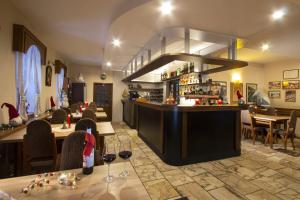 a restaurant with a bar with glasses of wine at Penzión Šafran Stratená in Stratená