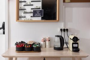 a table with cups and a coffee maker on it at Razin 37 in Eilat +10 photos