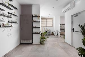 a room with white walls and a hallway with a table at Razin 37 in Eilat