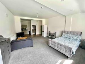 a living room with a bed and a desk at The Limes! Flat 3 Private Studio Apartment in Quinton