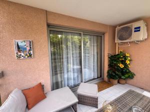 a living room with a couch and a large window at Le Saint Michel - MENTON#MONACO - 6 PERSONS - Parking- bord de mer in Menton