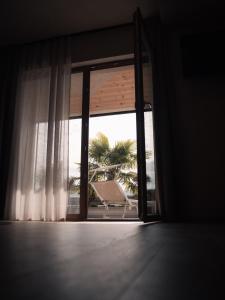 an open window with a view of a chair outside at Das Panorama Dependance in Caldaro