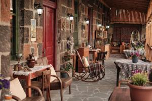 a restaurant with tables and chairs and a red door at Onoyi Tun Guest House in Gyumri
