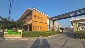 a building with a sign in front of it at Plumera Mactan Condo unit in Bankal