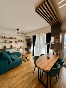 a living room with a blue couch and a table at Emerald Luxury Apartments in Skopje