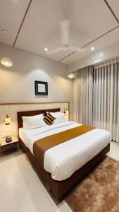 a bedroom with a large bed in a room at Balaji Hotel in Somnath +96 photos