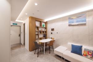 a living room with a white couch and a table at Seoul Modern Cozy Stay in Seoul