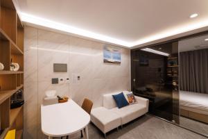 a small room with a white couch and a table at Seoul Modern Cozy Stay in Seoul
