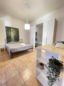 a living room with a bed and a table at DomuMnG in Elmas