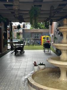 a fountain in a courtyard with chairs and a playground at Doña Emilia Hotel Boutique in Villarrica