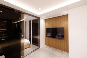 a bedroom with a bed and a tv on a wall at Seoul Modern Cozy Stay in Seoul