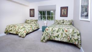 a bedroom with two beds and a window at 122 Mariners Club in Key Largo +45 photos