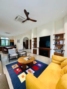 a living room with a couch and a ceiling fan at PhuQuoc Homestay in Long Bình