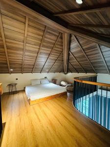 a bedroom with a bed and a wooden floor at PhuQuoc Homestay in Long Bình +11 photos