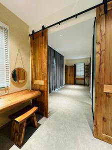a hallway with wooden walls and a wooden table and bench at PhuQuoc Homestay in Long Bình