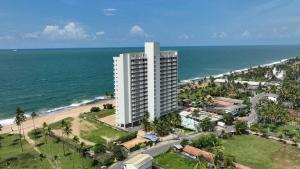 an aerial view of a building next to the ocean at Anarma Oceanfront Apartment in Wattala