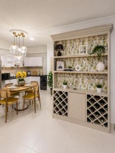 a kitchen and dining room with a table and a wine cellar at Anarma Oceanfront Apartment in Wattala