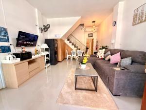 a living room with a couch and a table at Pause Homestay 2 Hat Yai in Hat Yai