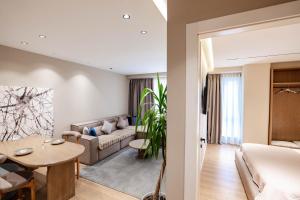 a living room with a couch and a table at Agate Hotel Tirana in Tirana