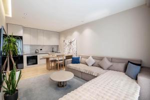 a living room with a couch and a table at Agate Hotel Tirana in Tirana