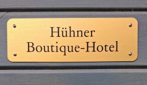 a sign that reads hunter boutique hotel on a wooden wall at Sonnenhügel in Neu Karin