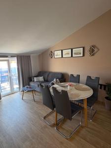 a living room with a table and chairs and a couch at Apartmani M&L in Medulin