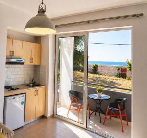 a kitchen with a table and a view of the ocean at Kleanthi Studios in Chania