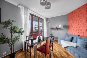 a living room with a table and a blue couch at Spacious 3Rooms Apt with Balcony Parking in Warsaw