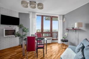 a living room with a table and a couch at Spacious 3Rooms Apt with Balcony Parking in Warsaw