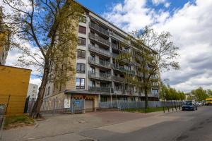 an apartment building on the side of a street at Spacious 3Rooms Apt with Balcony Parking in Warsaw