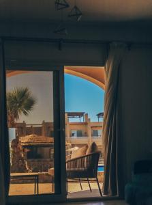 a room with a window with a chair and a view at Green studio in Dahab in Dahab
