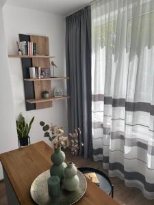a dining room with a table and a window at VYO Studio in Braşov +5 photos