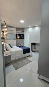 a bedroom with a large bed in a room at Residencial Felicita in Barueri