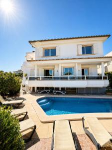 a villa with a swimming pool in front of a house at Villa Filipinas ,CITY CENTER -ETV10310 in Palma de Mallorca
