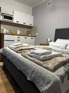 a bedroom with a bed with towels on it at Hello Tu Modlin in Zakroczym