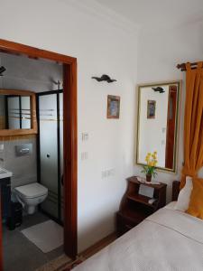 a bedroom with a bed and a toilet and a mirror at Yükser Pansiyon in Side