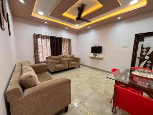 a living room with a couch and a tv at Crescent Holiday Homes in Panchgani +24 photos