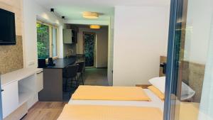 a room with two beds and a kitchen at Hupfmühle Pension in St. Wolfgang