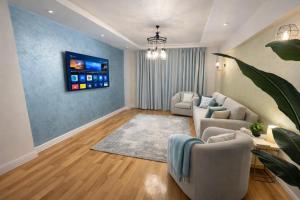 a living room with a couch and a table at The Perfect in Alexandria