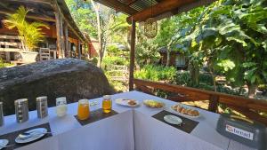 a table with two drinks and food on it at Lidwala Lodge in Ezulwini