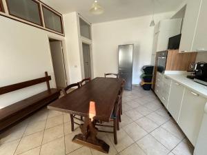 a kitchen with a wooden table in a room at Affittacamere VITRUVIO in Fano